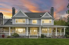 a large house sitting on top of a lush green field