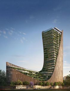 a tall building with lots of plants growing on it's side and the top part of its roof