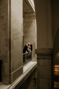 a man taking a selfie in the middle of a building's balcony area