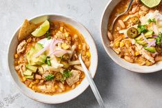 two bowls of mexican chicken soup with tortilla chips and avocado on the side