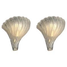 a pair of scallop shaped wall lights