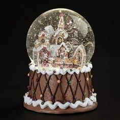 there is a snow globe on top of the cake