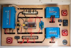 an electrical panel with many different types of wires and other electronic equipment on it,