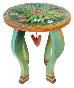 a small table with a heart hanging from it's center and two legs on each side