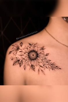 a sunflower tattoo on the back of a woman's shoulder