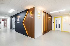 the interior of an office building with white walls and yellow trimmings on the doors