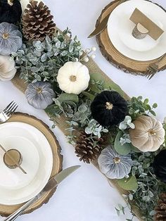 the table is set with black, white and gold place settings