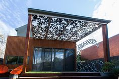 an outdoor patio covered in metal and wood