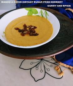 there is a bowl of soup with nuts on the side and a blue cloth behind it