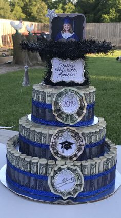 a three tiered cake decorated with dollar bills