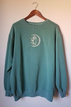 We are constantly trying to restock so please keep checking back if you dont see your size in stock or message me! Super Cute Embroidered Comfort Colors Sun and Moon Sweatshirt in Light Green with pale yellow embroidery. Very vintage and 90s style. These are made to order so they will take some time- Please consider this when ordering. These are adult unisex Comfort Colors sweatshirts (80% cotton / 20% polyester). Due to the vintage wash of Comfort Colors sweatshirts, the color may vary slightly Oversized Embroidered Tops For Loungewear, Oversized Crew Neck Top For Festival, Vintage Embroidered Oversized Tops, Cotton Aesthetic Relaxed Fit Sweatshirt, Long Sleeve Cotton Tops With Moon Print, Long Sleeve Cotton Top With Moon Print, Cotton Long Sleeve Tops With Moon Print, Fall Cotton Top With Moon Print, Casual Moon Print Tops For Festival