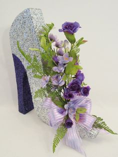 a purple shoe with flowers in it