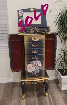 an old dresser with flowers painted on it and the word love spelled out in pink