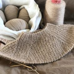 several skeins of yarn sitting on top of a bed