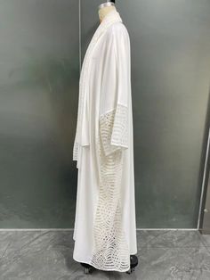 Embrace the purity and elegance of white with our "White Orchid Abaya Ensemble". This stunning ensemble combines the timeless allure of white with the grace and sophistication of traditional modest wear, creating a captivating look that is sure to turn heads. Perfect Gift :Whether for Eid, Ramadan, Mother's Day, birthdays, or any special occasion, the "White Orchid Abaya Ensemble" makes a thoughtful and elegant gift choice that will be cherished by your loved ones. Features: Exquisite White Fabr Modest Long White Thobe, Elegant Long White Abaya, Elegant White Long Sleeve Abaya, Elegant Long White Khimar, White Long Sleeve Abaya For Spring, White Long Kaftan For Eid, Traditional Long White Abaya, Traditional White Maxi Length Abaya, White Long Sleeve Kaftan For Daywear