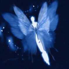 a blue angel with white wings flying through the night sky and stars in the background