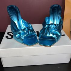 Metallic Blue Sandals 100mm Heal Square Toe. Sleek And Fashionable Mule. New Never Worn. Original Box And Dust Bag Included. Purchased Directly From Schutz Website. Party Mules With Padded Wedge Heel, Blue Sandals With 4-inch Heel For Party, Blue Pointed Toe Sandals For Night Out, Blue Party Sandals With 4-inch Heel, Blue Pointed Toe Sandals For Party, Blue Open Toe Party Mules, Trendy Blue High Heel Mules, Chic Party Mules With Wedge Heel, Chic Blue Sandals For Night Out