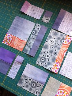 several pieces of fabric laid out on a cutting board