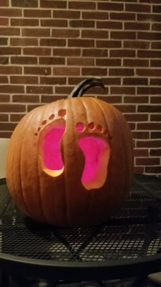 a pumpkin shaped like a person's foot with pink light inside