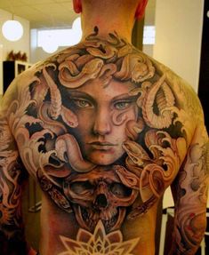 a man with many tattoos on his back