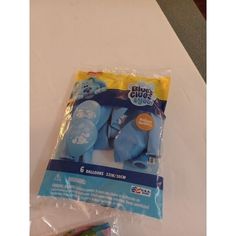 there is a package of blue elephant toys on the table with it's packaging