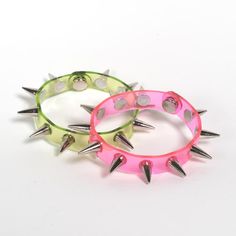 Apatico - Spiked Bangle Bracelet - UV Pink - Lime Green - Clear PVC Trendy Adjustable Spiked Bracelets, Multicolor Punk Jewelry For Parties, Punk Multicolor Party Jewelry, Edgy Pink Party Jewelry, Punk Style Party Bangle Bracelet, Silver Spiked Bracelets For Parties, Edgy Spiked Jewelry For Parties, Trendy Spiked Jewelry For Parties, Uv Aesthetic