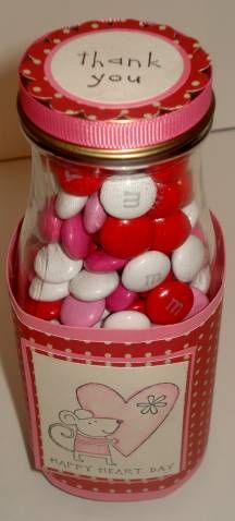 a jar filled with lots of candy sitting on top of a table