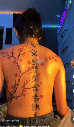 the back of a woman's body with chinese writing on her upper and lower back