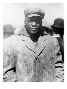 an old black and white photo of a man wearing a coat, hat and glasses