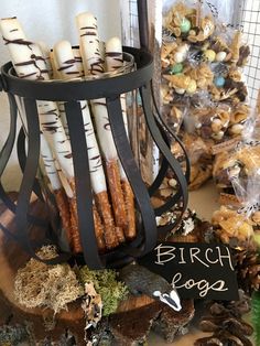 a basket filled with lots of different types of food next to a sign that says birch logs