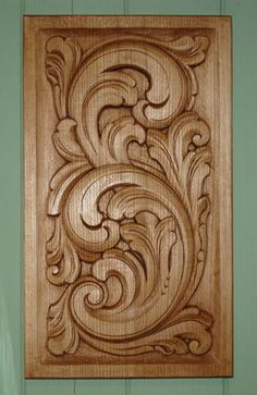 an intricate wood carving on the side of a door