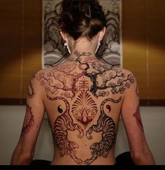 a woman with tattoos on her back