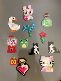 pixel art magnets are displayed on a refrigerator freezer door in this image, there is an assortment of different types of stickers and shapes