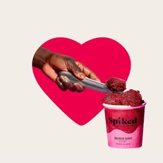 a hand holding a spoon over a cup of ice cream in front of a heart