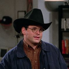 a man wearing a cowboy hat and glasses