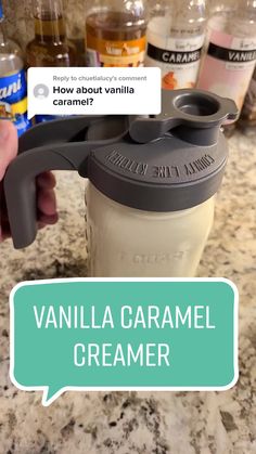 a person holding a cup with the words vanilla caramel creamer in front of them