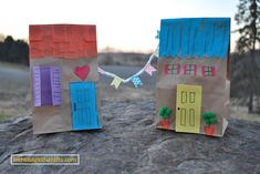 two paper bags with small houses on them