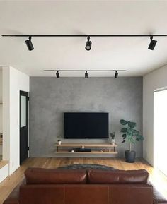 a large flat screen tv mounted to the side of a wall in a living room