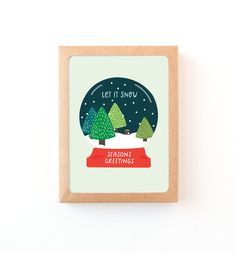 a greeting card featuring trees and the words, let it snow season's greetings