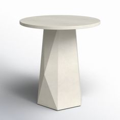 a white table sitting on top of a white floor