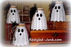 three white ghost decorations sitting on top of a wooden box