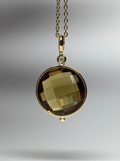 Please, read full description! Please, don't rely on your expectations, the exact size is described below  14k solid yellow gold, natural white diamond and dark honey brown "cognac" quartz pendant.  The chain is not included!  The gemstone is genuine "cognac" quartz, double sided checkerboard cut, 8.5 carats, 14mm round.  The diamond is 1.7mm round, 0.02ct, natural, white, nice and sparkly. Weight of the pendant is 2.17g Bail is 3mm by 4mm (inside opening) Top-bottom length, including bail, is 24mm (1") Stamped 14k Chain is not included Any thin chain will fit Pendant comes with a small velvet envelope pouch. RETURNS AND EXCHANGES are accepted within 30 days of the delivery, in unworn and undamaged condition. If you wish to return the item, please, contact me for the instructions. The retu Luxury Brown Necklace With Large Pendant, Velvet Envelope, Envelope Pouch, Deep Autumn, Red Sunset, Honey Brown, Quartz Pendant, Solid Yellow, White Diamond