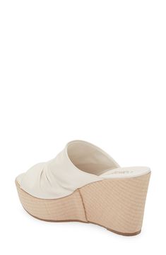 A ruched vamp lends contemporary dimension to an espadrille-inspired slide sandal lifted by a jute-wrapped platform and integrated wedge heel. 4" heel; 2" platform Cushioned footbed Leather upper and lining/rubber sole Made in Italy White Platform Slip-on Wedge Sandals, White Synthetic Slip-on Wedge Sandals, Beach Slip-on Platform Wedge Sandals, Beach Slip-on Wedge Sandals With Woven Sole, Beige Slip-on Wedge Sandals With Woven Sole, Espadrilles Platform, Platform Wedges, Slide Sandals, Wedge Heels