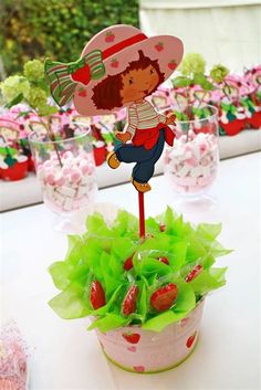 a table topped with cupcakes and strawberries