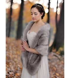 a woman wearing a wedding dress and fur stole