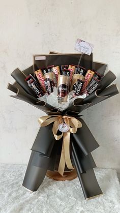 a vase filled with chocolates and wrapped in ribbon