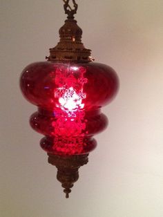 a red light hanging from a ceiling in a room