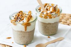 two desserts in small glass jars with spoons