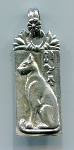 a silver pendant with an animal on it