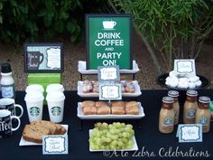 a table topped with drinks and food next to a sign that says drink coffee bar